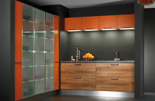 una cucina contemporanea con cassetti colorati, alzatina grigia e tomaie arancioni, un frigorifero in vetro arancione