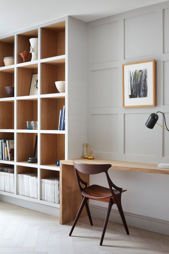 un bellissimo ufficio in casa minimalista con librerie componibili e una piccola scrivania incorporata è uno spazio elegante