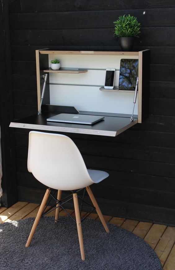 un'elegante scrivania pieghevole a parete in colori neutri e scuri è un'idea molto elegante adatta a piccoli spazi