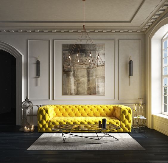 un divano trapuntato giallo super audace fa una bella dichiarazione in uno spazio neutro